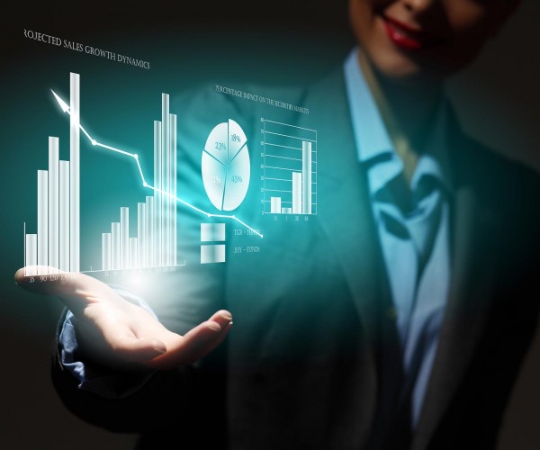 Close up of businesswoman holding graphs in hand
